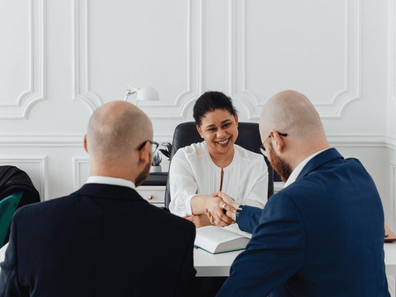 Mortgage broker and business owner shakes hands, agreeing on a bad credit emergency loan solution
