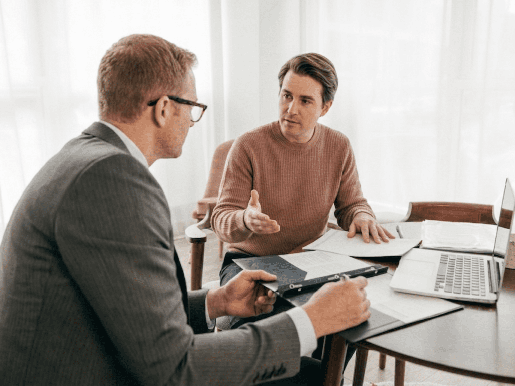 A business owner meets with a finance broker to talk about loan options after receiving a garnishee notice