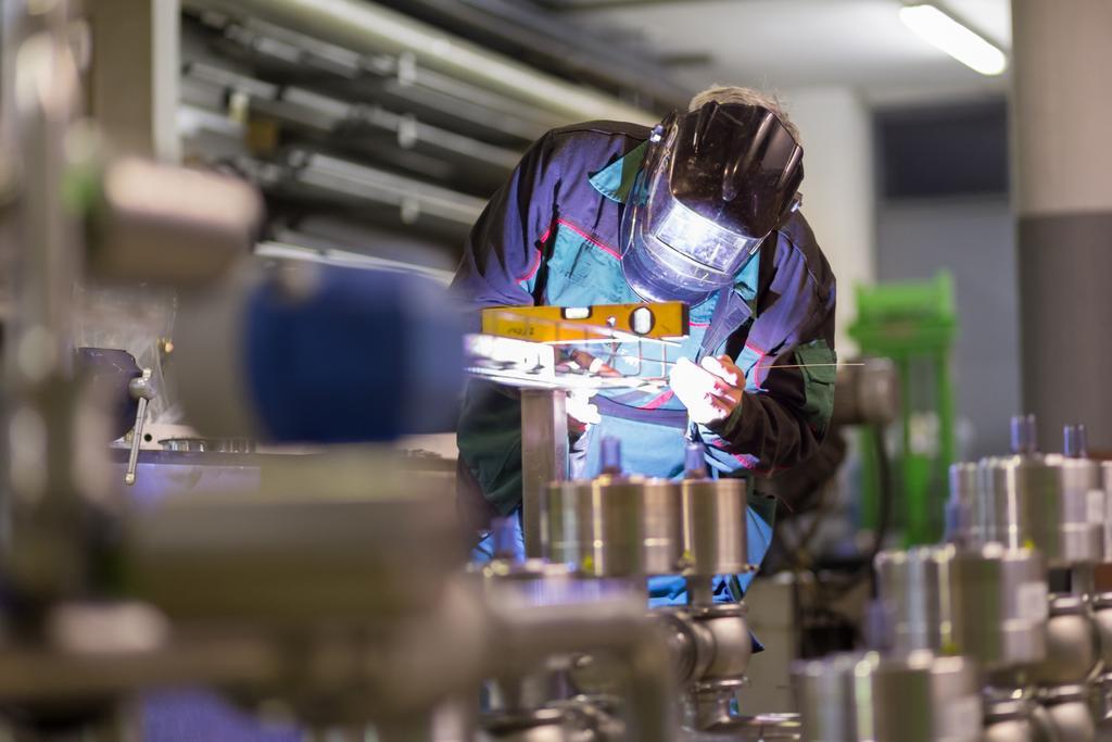 Industrial worker with protective mask welding