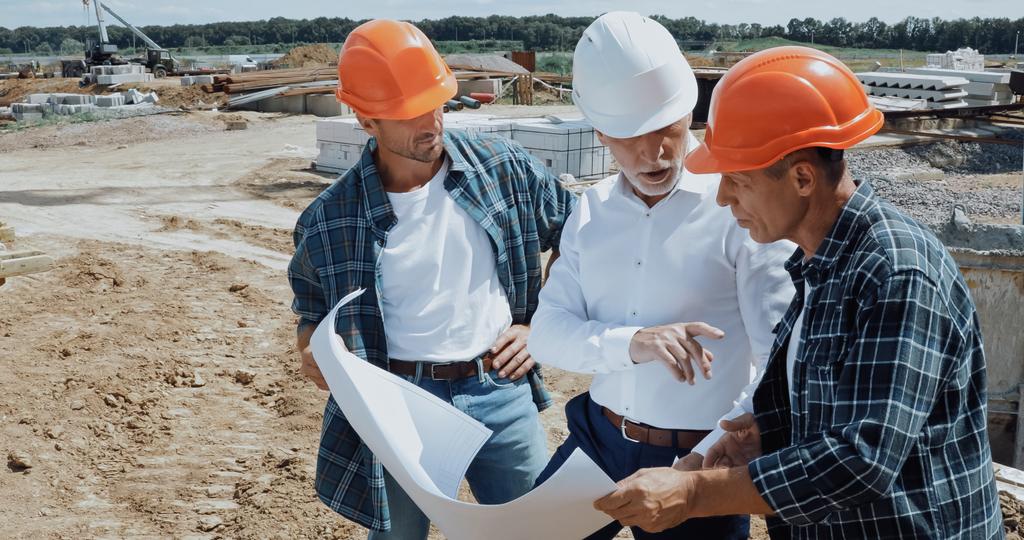 A group of contractors and engineers discussing a construction project