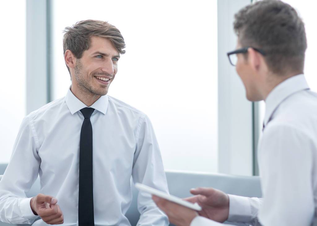 Businessman explaining to client about overhead costs for his business