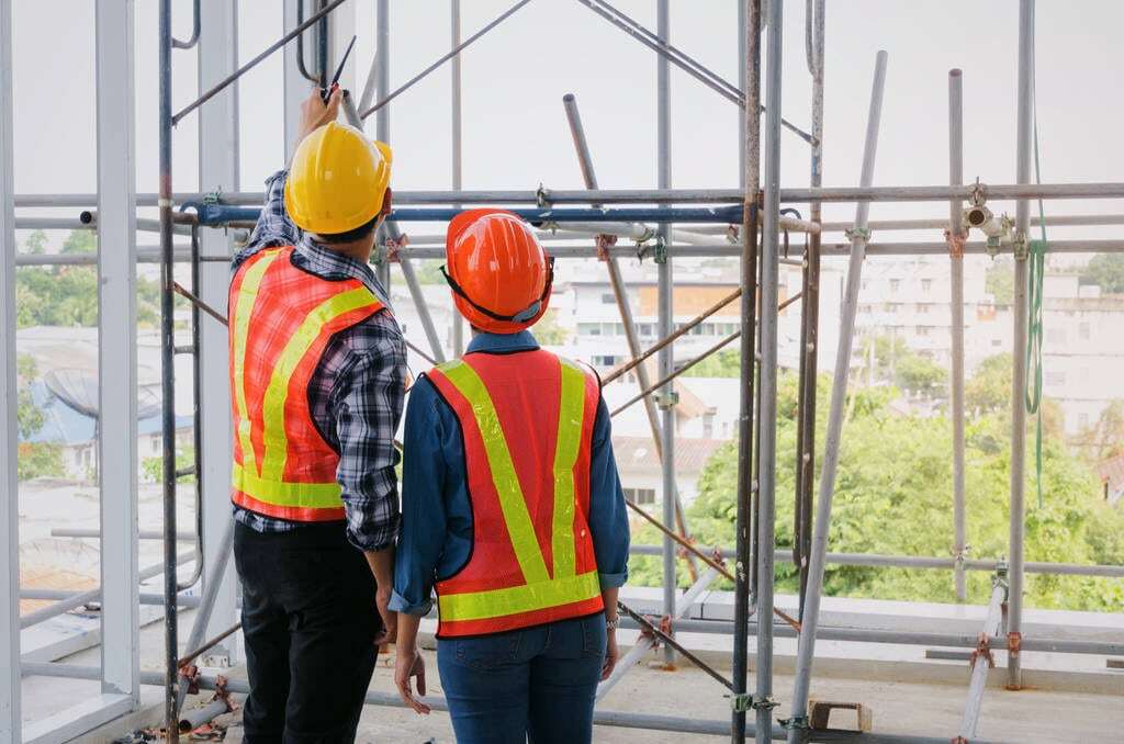 Two construction workers discussing plans
