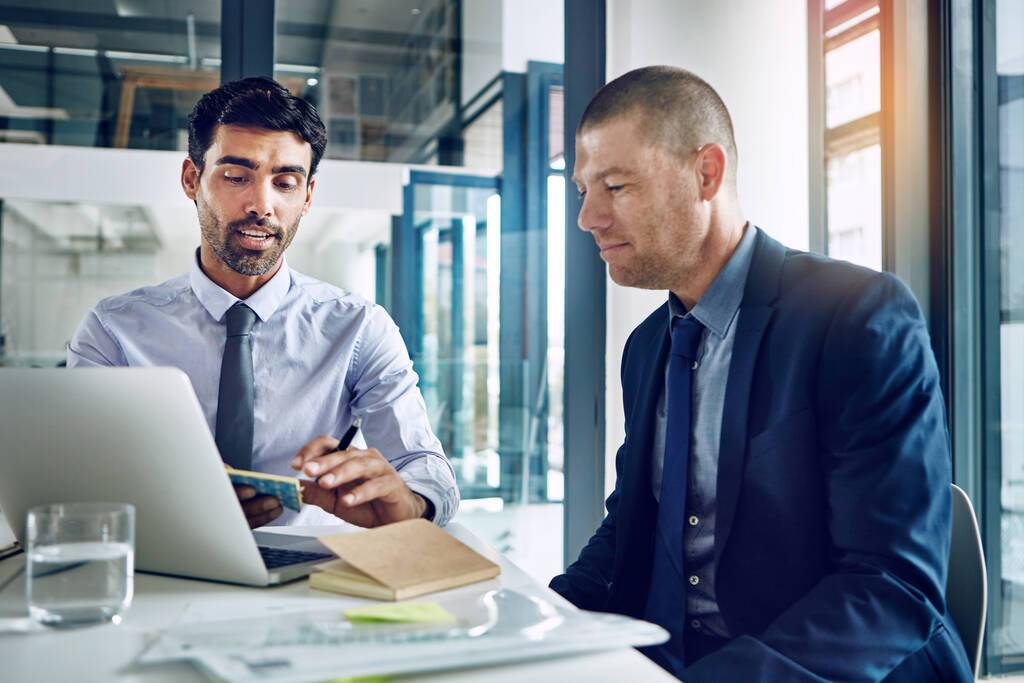 Financial advisor with client looking at long term financing options
