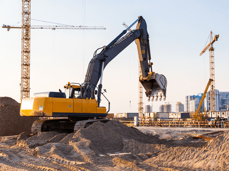 A large industrial excavator being operated on a new construction site for a building project