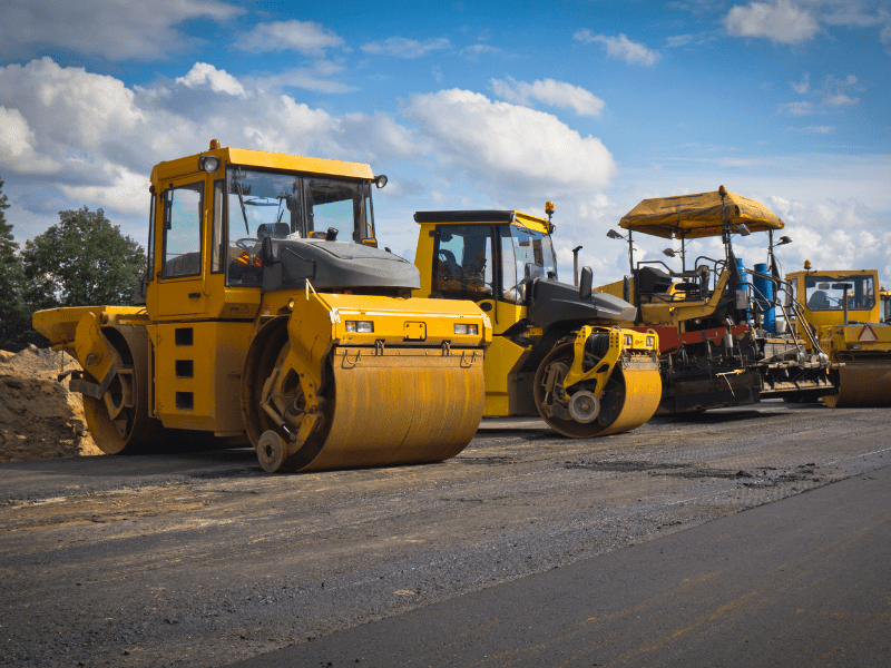 Large yellow road rollers parked next to each other