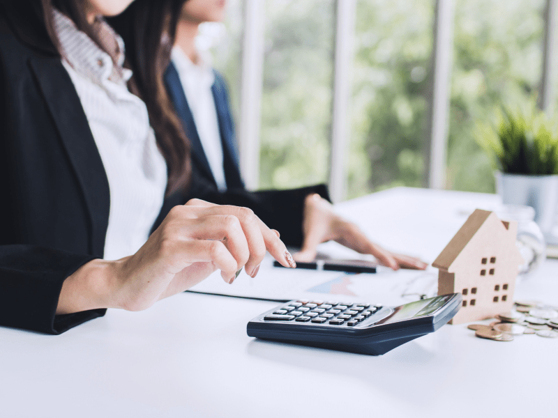 Cropped photo of woman using calculator