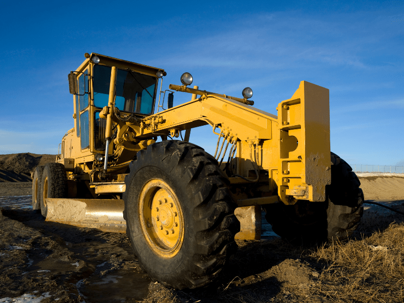 Yellow construction equipment with blue skies in the background