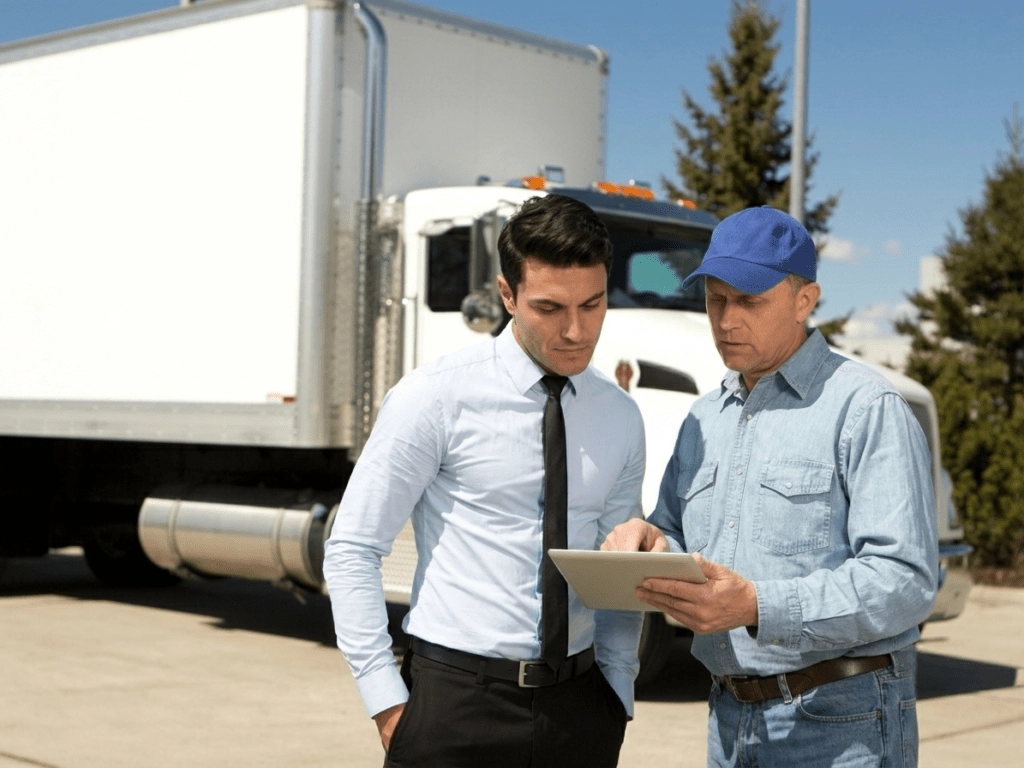 A mortgage broker talks to a trucking business owner about tax debt loan options to replace a cancelled payment plan