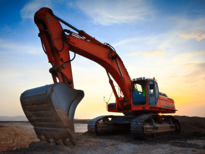 A large orange excavator at a construction site