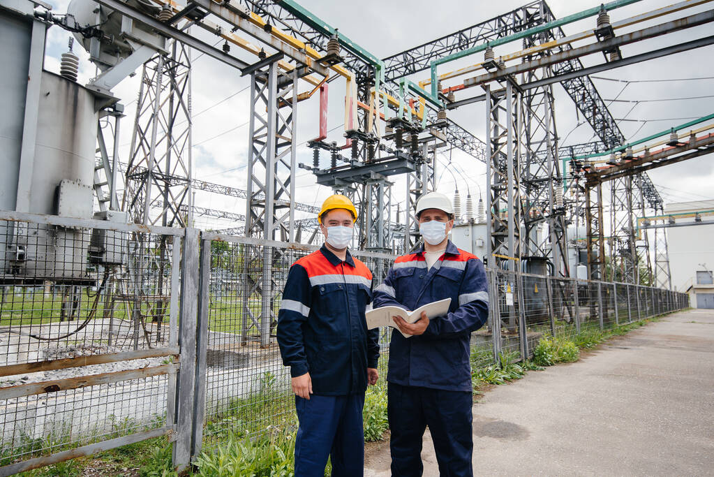 Engineers electrical substations conduct a survey 