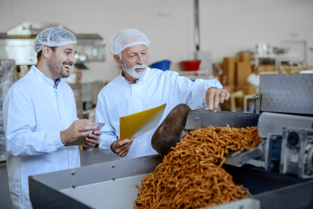 Two employees looking at the food manufacturing