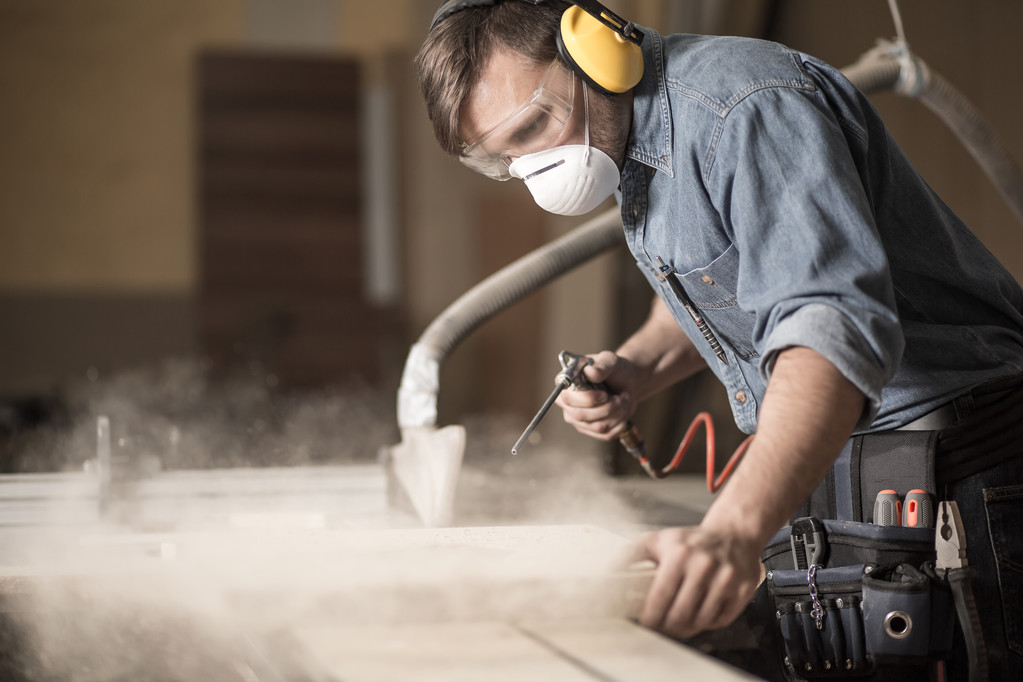 carpenter varnishing a board