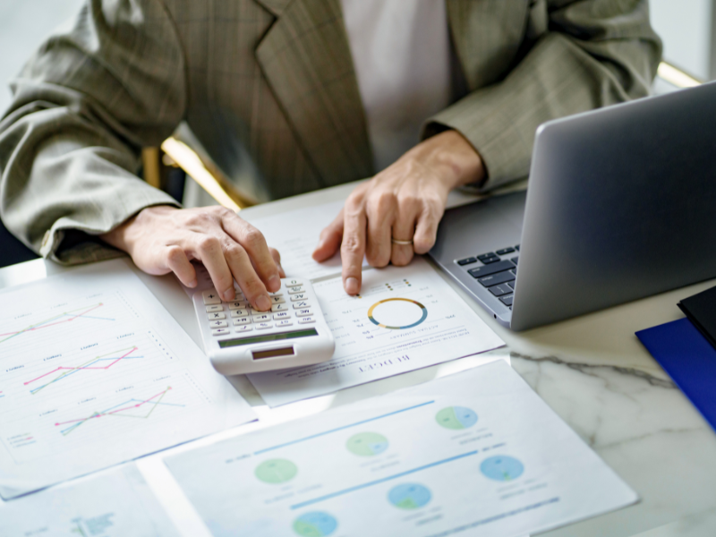 Cropped photo of a business owner reviewing their company budget based on cash flow and using a calculator