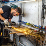 man using angle grinder in the workshop