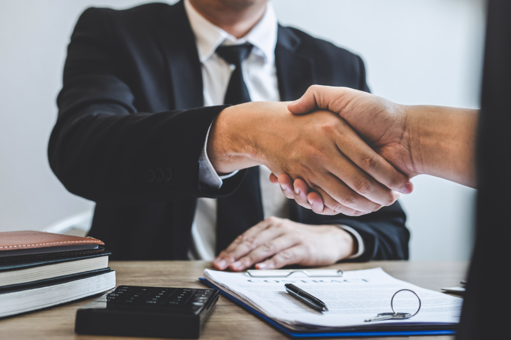Cropped POV photo of client shaking hands with sharply dressed lender or mortgage broker, agreeing on tax debt loans, signing a loan agreement