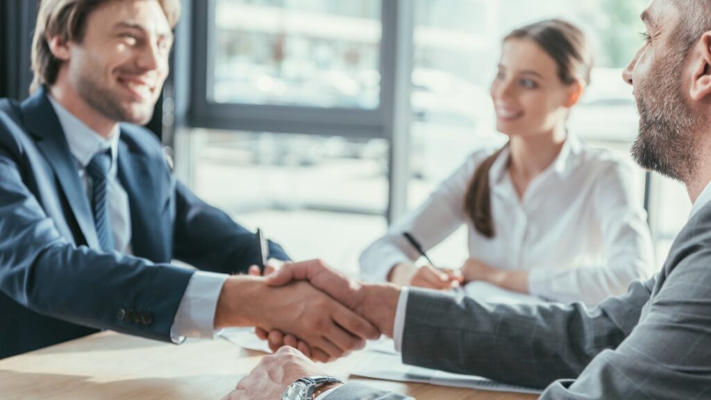 Business people shaking hands during meeting at modern office