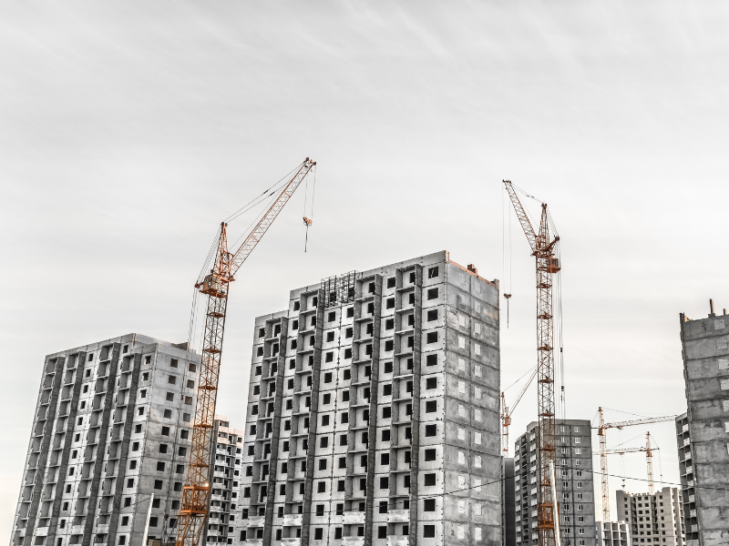 An ongoing multi building construction with several cranes working on the build