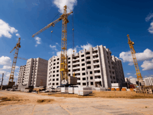 An ongoing building construction project with three cranes