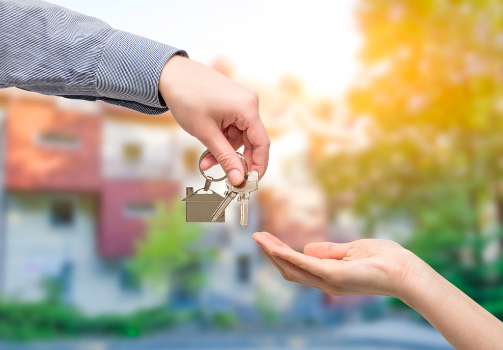 Stock Photo Man Is Handing A House Key To A Woman Real Estate Concepts