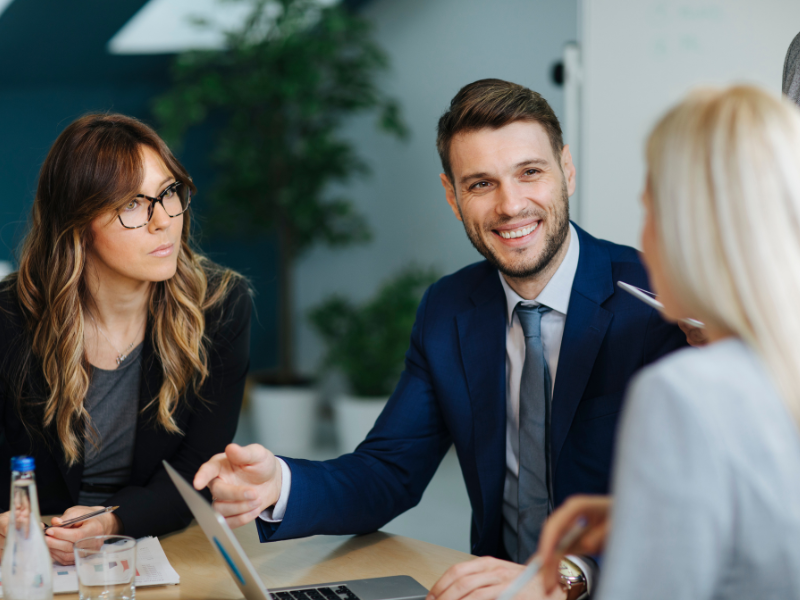 A mortgage broker happily discusses unsecured loans with business owners