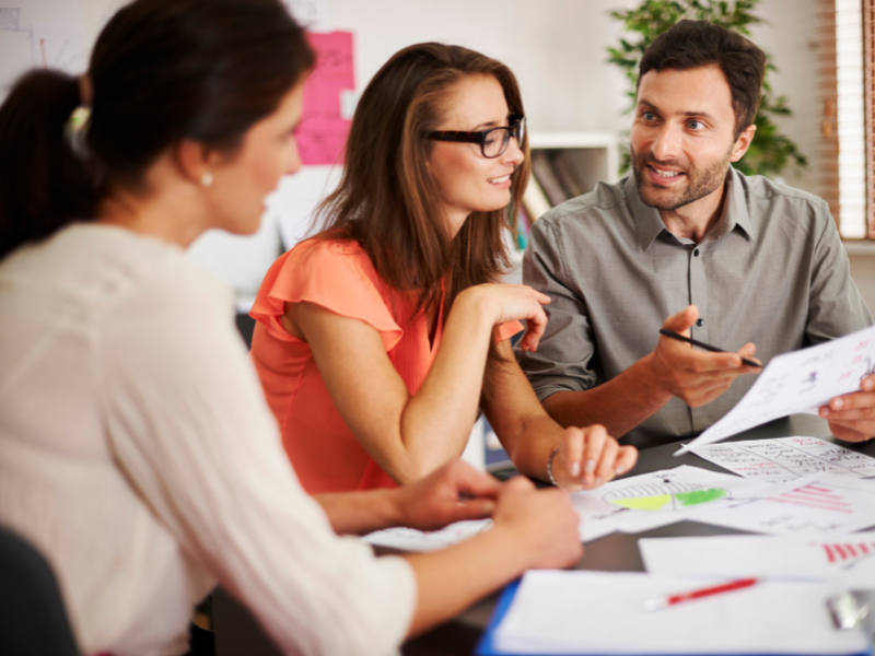 Business owners speaking to a mortgage broker about unsecured loans