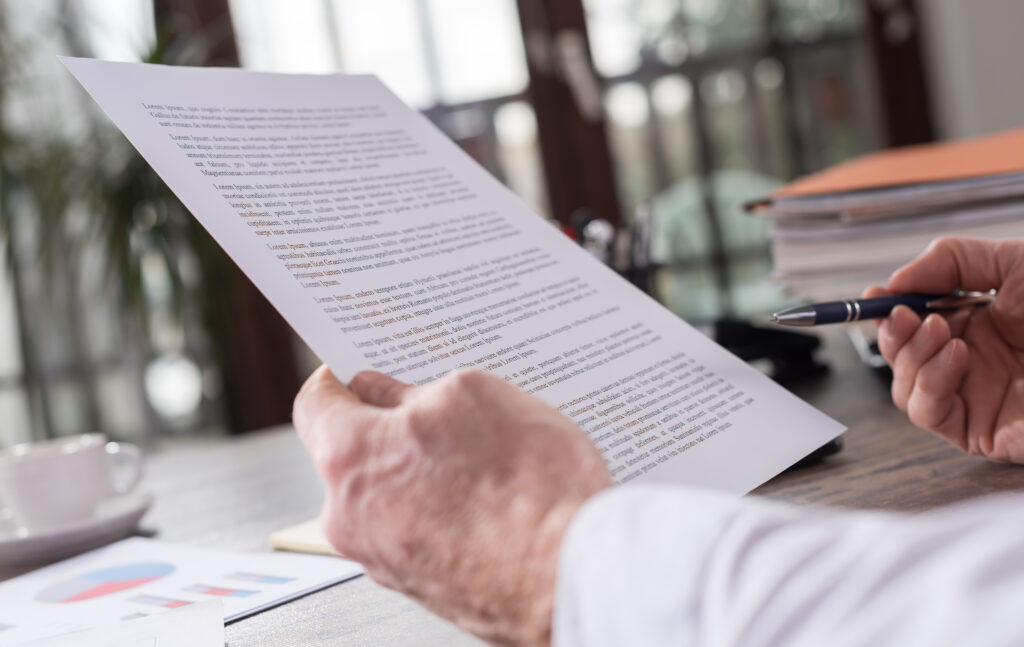 How loan terms affect your business - Concept photo, view of a man's hands examining a document