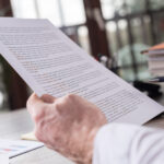 How loan terms affect your business - Concept photo, view of a man's hands examining a document