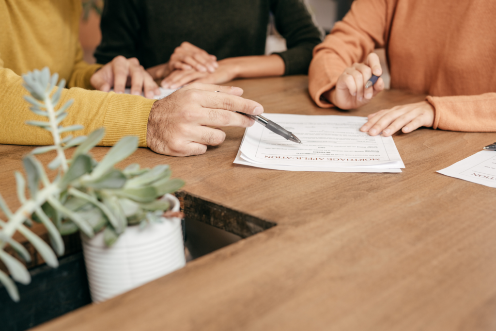 Cropped photo of mortgage broker showing documents and calculations to client, discussing refinancing, choosing refinance lender, concept photo