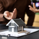 Client and mortgage broker or lender discussing SMSF loans for investment, concept photo, cropped photo of discussion, files and model miniature house visible