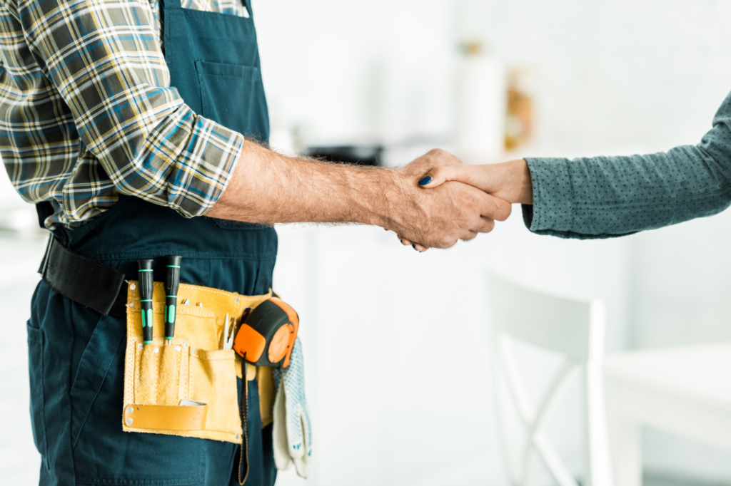 Cropped photo of plumber shaking hands with woman, concept photo of plumbing business owner agreeing to a loan solution with a loan broker