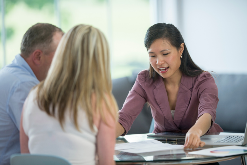 Woman discusses documents with a middle-aged couple, concept photo of loan expert explaining the SMSF Loan Application Process