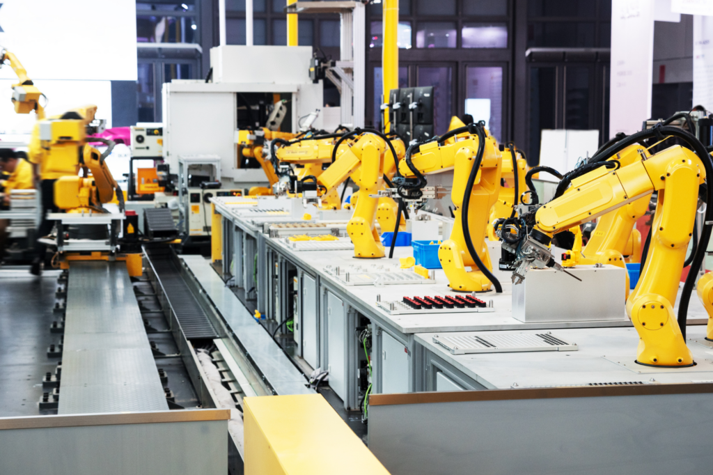 Photo of a very clean and sterile factory with rows of yellow robotic arms, advanced machinery, pharmaceuticals, concept photo of using business equipment for asset based commercial loans