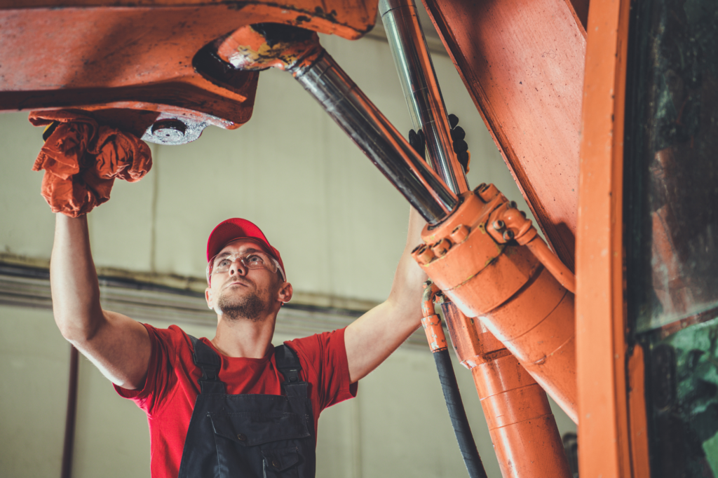 Man maintaining trucks and equipments