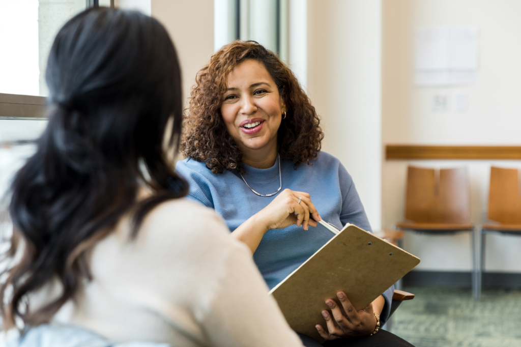 Two women in a cheerful professional discussion, concept photo for a business owner considering private lending for her business