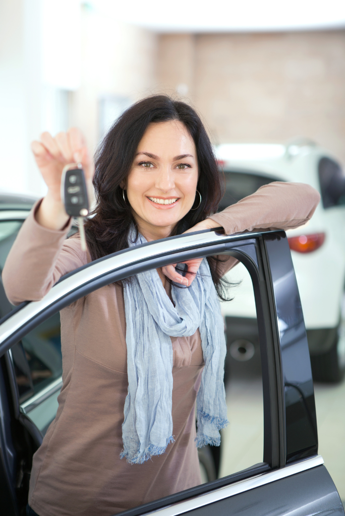 Happy woman showing her newly loaned car in Australia