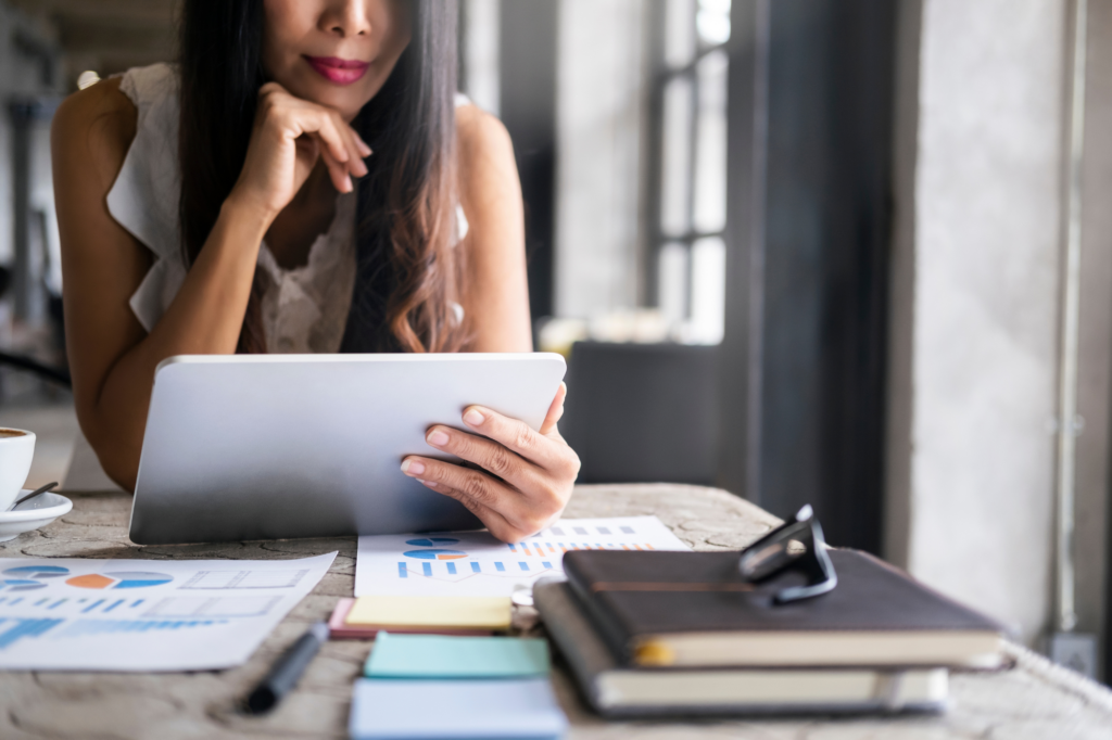 Cropped photo of a woman reading the screen of an electronic tablet, a woman examining her home equity for debt recycling