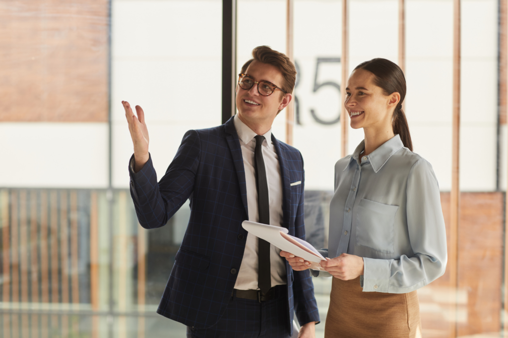 A man shows a woman around a commercial property, Using commercial property for SMSF Loans