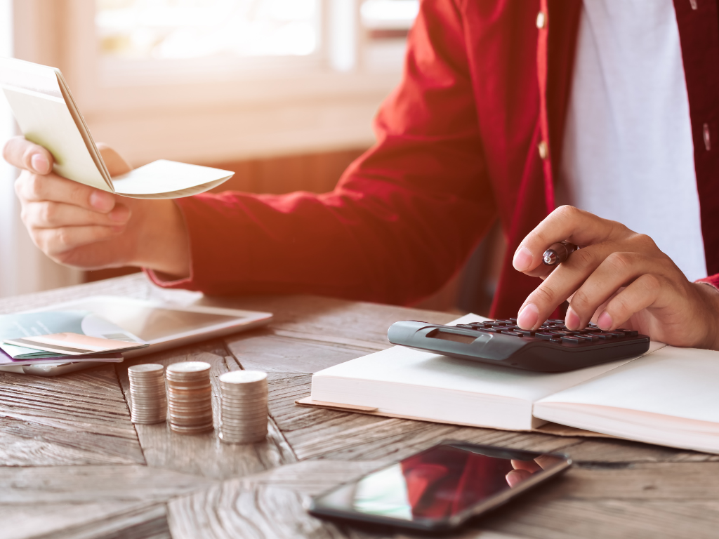 Zoomed and cropped photo of a man calculating finances in preparation for debt recycling