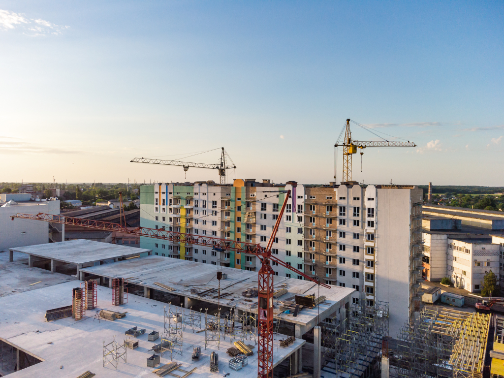 Wide angle view of an ongoing construction project for a mid-rise development, concept photo of a development funded through commercial financing