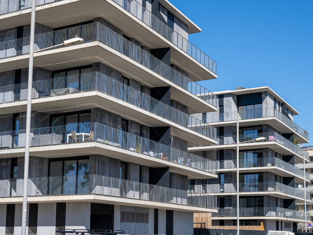 Brightly-lit photo of mid-rise apartment complexes, property development, concept photo for units used in residual stock finance