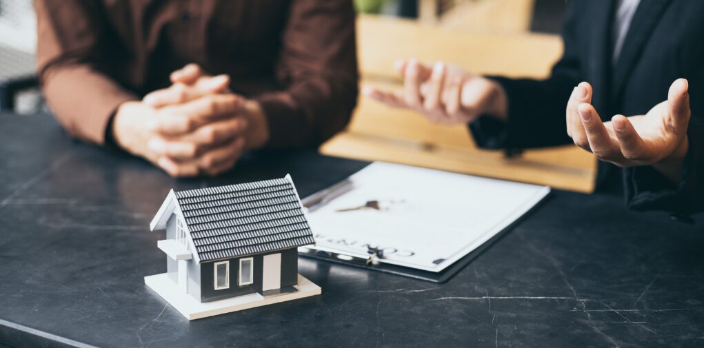 A person sitting next to a financial advisor, preparing to discuss options for choosing the right second mortgage and the best second mortgage loans tailored to their needs.