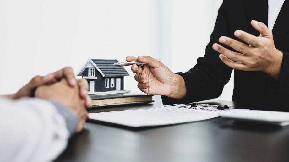 Two people sitting at a table, discussing financial options, focusing on choosing the right second mortgage and exploring how to choose the right second mortgage and the best second mortgage loans available.