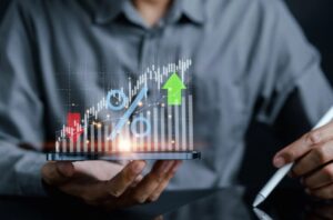 A businessman reviews an accounting report showing a business chart with increasing and decreasing percentages, highlighting the fragility of the U.S. economy and its ripple effects on Australia's financial markets and business performance.