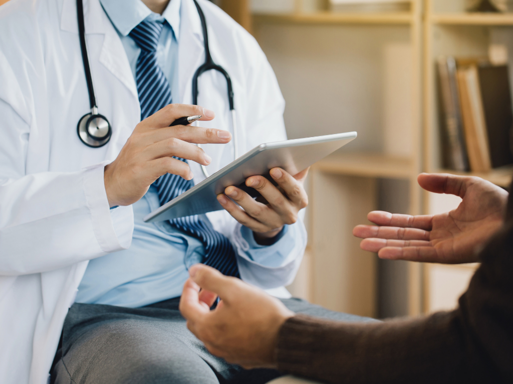 Cropped photo of a health professional or doctor discussing diagnostic results with a patient