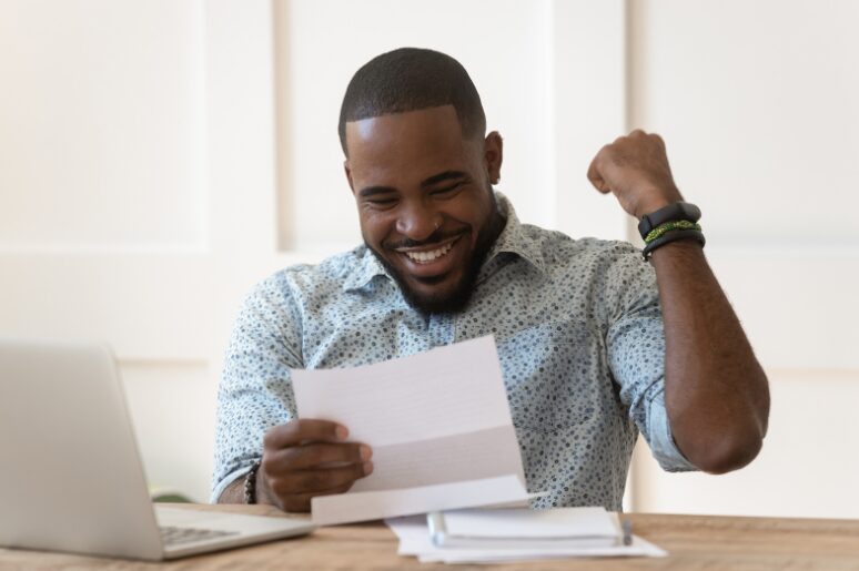 Business owner celebrating loan approval, representing the benefits of an unsecured business overdraft vs secured business overdraft.