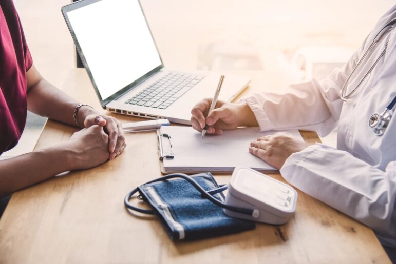 A medical professional discussing medical fitout finance options with a financial expert, exploring medical fitout loans and fitout financing for medical business to fund a practice upgrade.