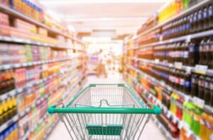 A shopping trolley in a supermarket aisle, showcasing the need for modern store upgrades made possible with fitout financing for retailers.