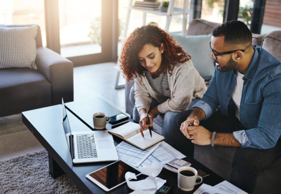 A male and female business team reviewing financial documents, discussing fitout finance requirements to determine how to qualify for a fitout financing.