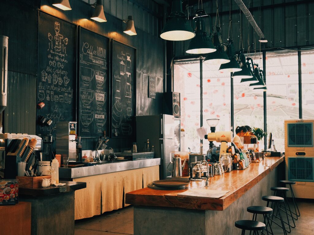 Interior of a coffee shop or cafe, black and wood industrial style design elements with large windows