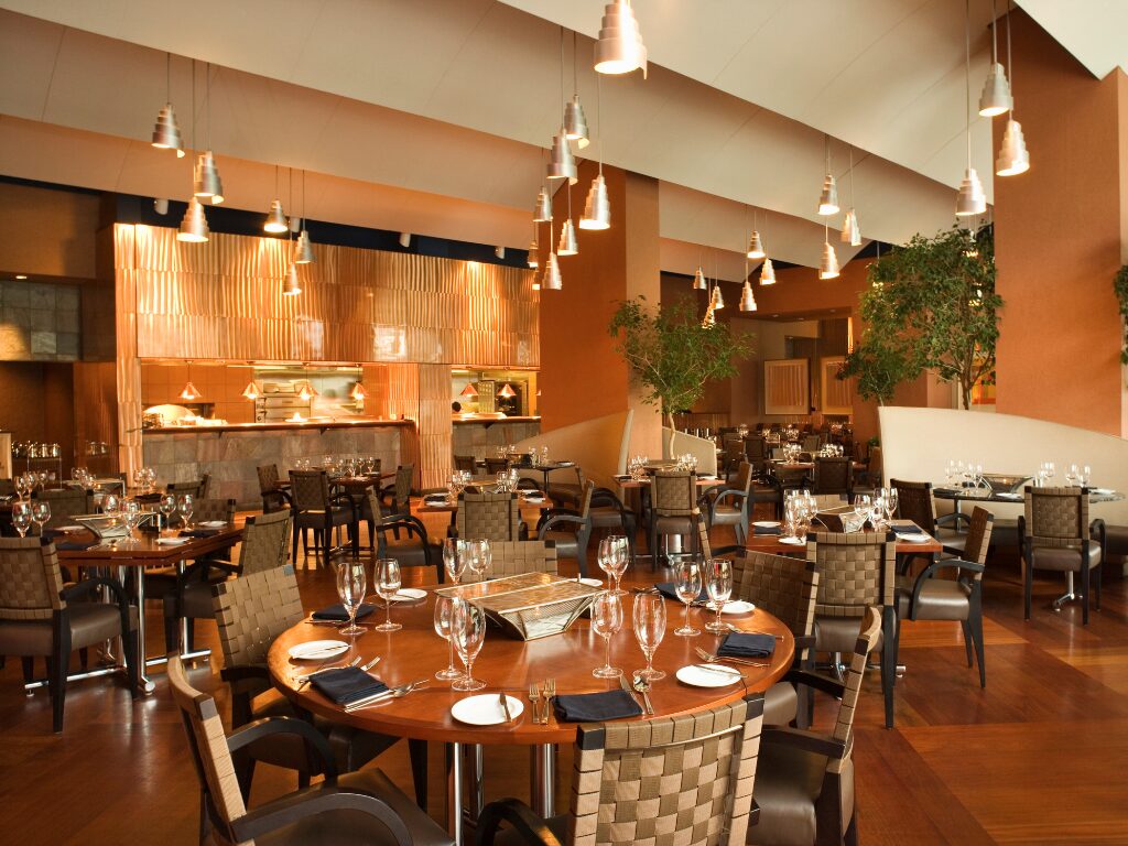 Warm and inviting restaurant interior design, empty fine dining restaurant with wood tones and warm lighting, interior design paid for using fitout financing for hospitality business